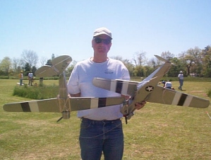 Jack Lewis holding his two battle damaged P-40 Warhawks - photo by Shepherd