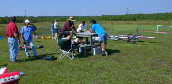 Several of the demonstration pilots talk about flight routines just before the opening of Founder's Day - Atkinson photo